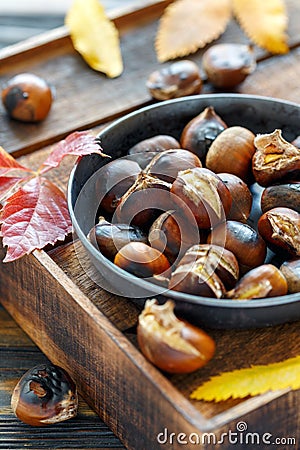 Roasted chestnuts in a cast iron skillet. Stock Photo