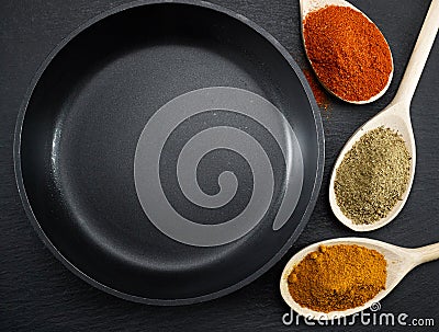 Frying pan and various spices Stock Photo