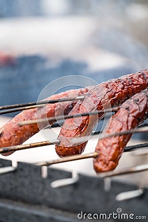 Frying sausages on a home made grill Stock Photo