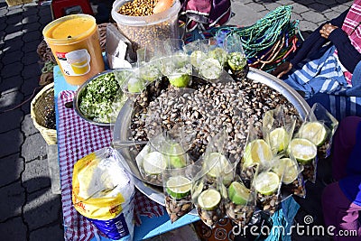 fsnails with lemon, a traditional snack on the counter at the rural market of Otavalo Editorial Stock Photo