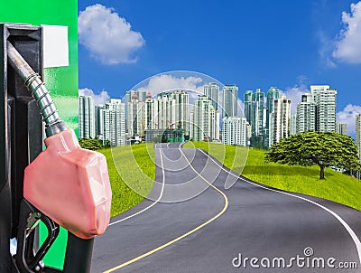 fuel nozzle service station with empty asphalt road and modern city Stock Photo