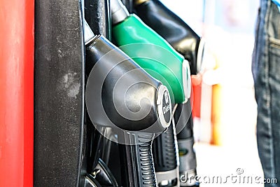 Fuel pistols at gas station, focus on diesel one Stock Photo