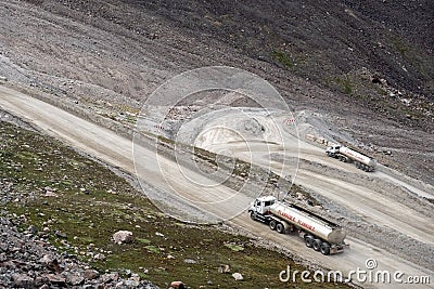 Fuel truck on dangerous gravel mountain road transporting diesel fuel to Kumtor gold mine. Industry freight truck transportation Stock Photo