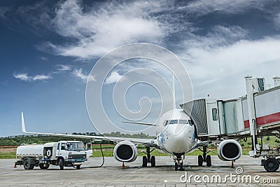 Fuel truck filling aviation fuel for plane Editorial Stock Photo