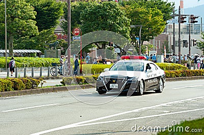 Tokyo 2020 Olympic Torch Relay. Car parade with police car ensuring safety in Fuji City, Japan Editorial Stock Photo