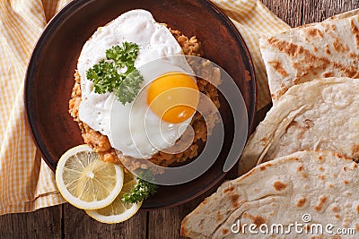 Ful medames with a fried egg and bread close-up. horizontal top Stock Photo
