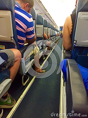 Interior of Airplane with Passengers on board Editorial Stock Photo