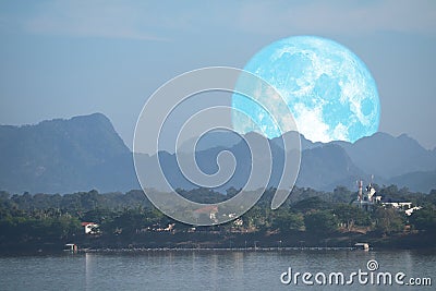 full Beaver Moon back on mountain and reflection on river in the night sky Stock Photo