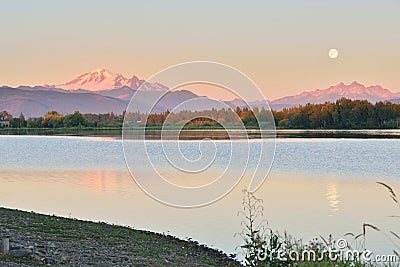 Full Blue Moon over Mt. Baker and Three Sisters Mountain Stock Photo