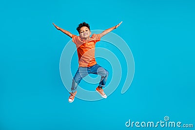 Full body cadre of jumping energetic latin small kindergarten age boy hands up positive star symbol hands isolated on Stock Photo