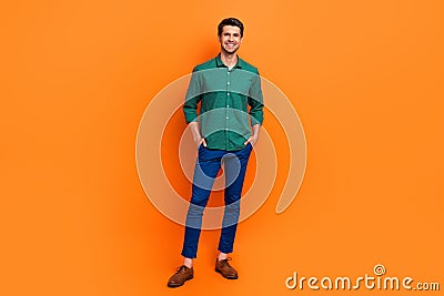 Full body photo of attractive positive brunet hair guy handsome successful entrepreneur model posing isolated on orange Stock Photo