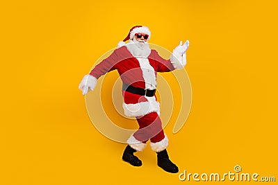 Full body photo of charismatic crazy santa dancing enjoy new year clubbing isolated on yellow color background Stock Photo