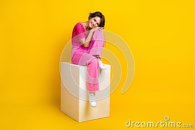 Full body photo of chill relaxed woman wear pink glamour knitted garment sit cube chair satisfied her lifestyle isolated Stock Photo