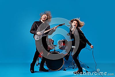 Full body photo crazy funky two people popular artist man play bass guitar girl sing composition mic solo enjoy punk Stock Photo