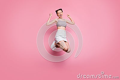 Full body photo of delighted positive girl jump win lottery have discounts news scream yeah yes raise fists feel rejoice Stock Photo