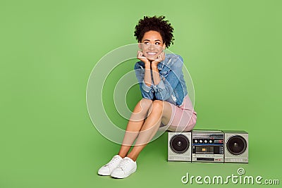 Full body photo of dream young lady sit with boom box wear dress shirt sneakers isolated on green background Stock Photo