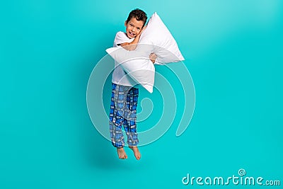 Full body photo of excited small person jumping hands hold comfort cushion empty space isolated on teal color background Stock Photo