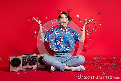 Full body photo of fairy tale magic party xmas young woman raised hands up decoration confetti boombox isolated on red Stock Photo