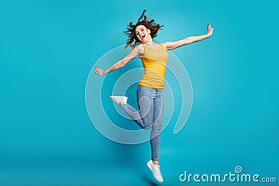 Full body photo overjoyed lady good mood jump high up rejoicing wear casual clothes isolated blue color background Stock Photo