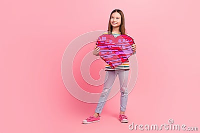 Full body photo picture small young age person girl brown hair hold her favorite candies surprise heart isolated on pink Stock Photo