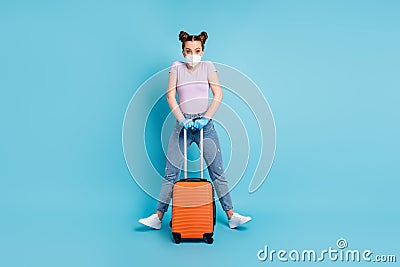 Full body photo of pretty lady use respirator pass check-airport hold rolling case fly home parents viral control Stock Photo