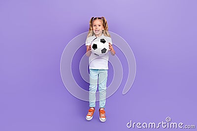 Full body photo of sporty little girl tails goalkeeper jump catch ball wear stylish white look on violet color Stock Photo