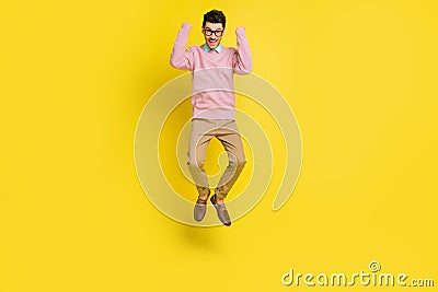 Full body photo of young excited man happy positive smile excited rejoice win victory jump up isolated over yellow color Stock Photo