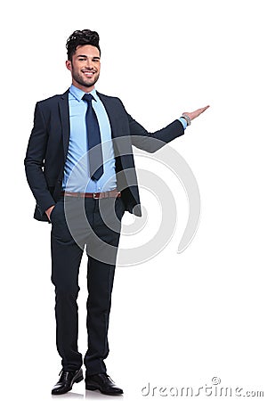 Full body picture of a happy business man presenting Stock Photo