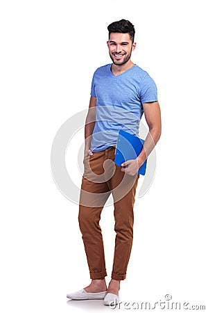 Full body picture of a young casual man holding notepad Stock Photo