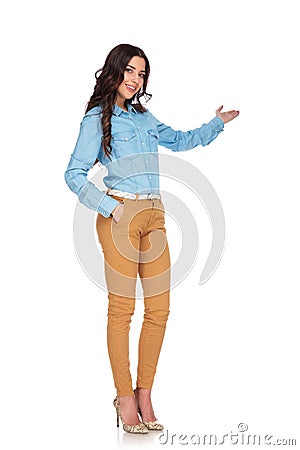 Full body picture of a young casual woman presenting Stock Photo