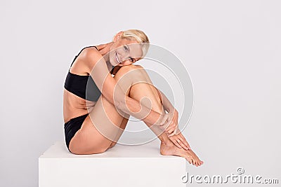 Full body portrait of feel young after yoga lesson mature lady underwear concept buy light cotton panties isolated on Stock Photo