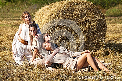 Full body portrait four young beautiful models in a beige dress Stock Photo