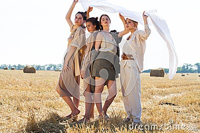 Full body portrait four young beautiful models in a beige dress Stock Photo