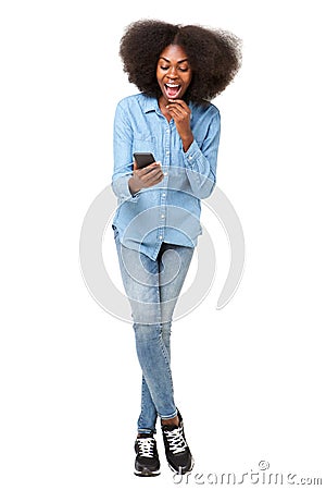 Full body surprised young woman looking at mobile phone Stock Photo