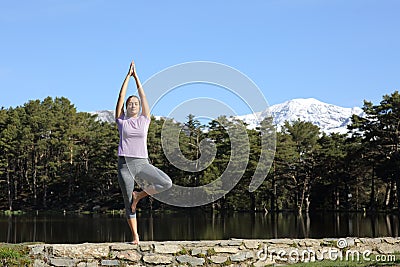 Yogi practicing yoga standing in the mountain Stock Photo
