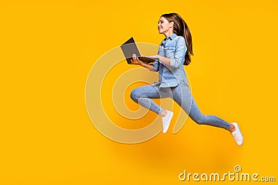 Full body profile photo of pretty business lady jump high holding notebook hands hurry work browsing laptop wear casual Stock Photo