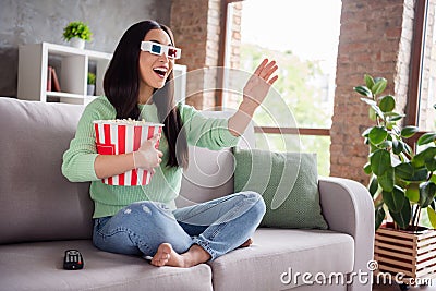 Full body profile side photo of surprised positive asian girl watch 3d film impressed modern effect hold pop corn box Stock Photo