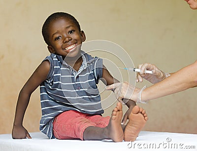 Full body shot of a happy African black child getting a needle injection as a medical vaccination Stock Photo