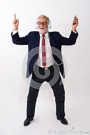 Full body shot of happy senior bearded businessman smiling while Stock Photo