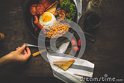 An English breakfast is a breakfast meal that typically includes bacon, sausages, eggs .. Stock Photo