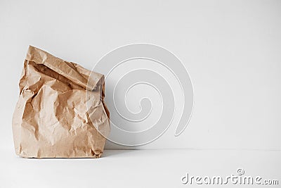 Full crumpled disposable bag of brown kraft paper on a white background. Copy, empty space for text Stock Photo