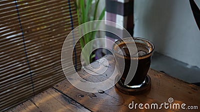 A full cup of coffee on the table. Stock Photo