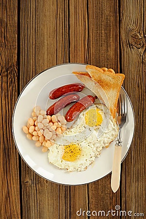 Full english breakfast with eggs, sausages, beans, toasts Stock Photo