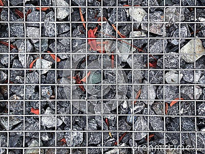 Background of Gravel Stones with Dry Leaves Under Metal Wire Mesh Stock Photo