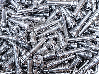 Full frame background of pile of shiny long steel parts, clean steel rods after fine cnc turning - laying chaotically Stock Photo