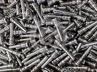 Full frame background of pile of shiny long steel parts, clean steel rods after fine cnc turning - laying chaotically Stock Photo