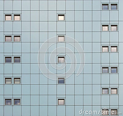 Facade of a modern building with geometric metallic cladding and repeating pattern windows Stock Photo