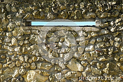 Rustic rubble stone wall construction around a swimming pool Stock Photo