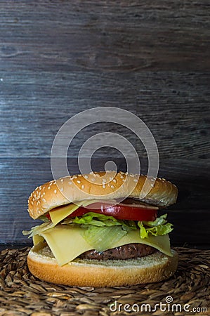 Full hamburguer on rustic background Stock Photo