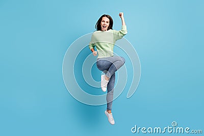 Full length body size photo of cheerful jumping girl wearing casual clothes shouting happily keeping hand up like winner Stock Photo